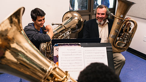 Students work with a tuba instructor