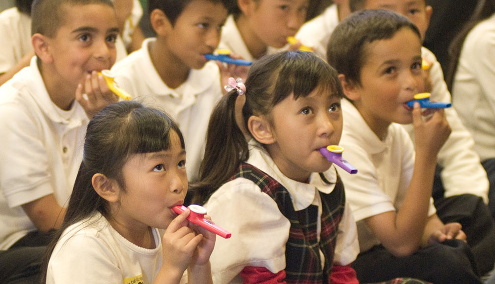 Children playing kazoos