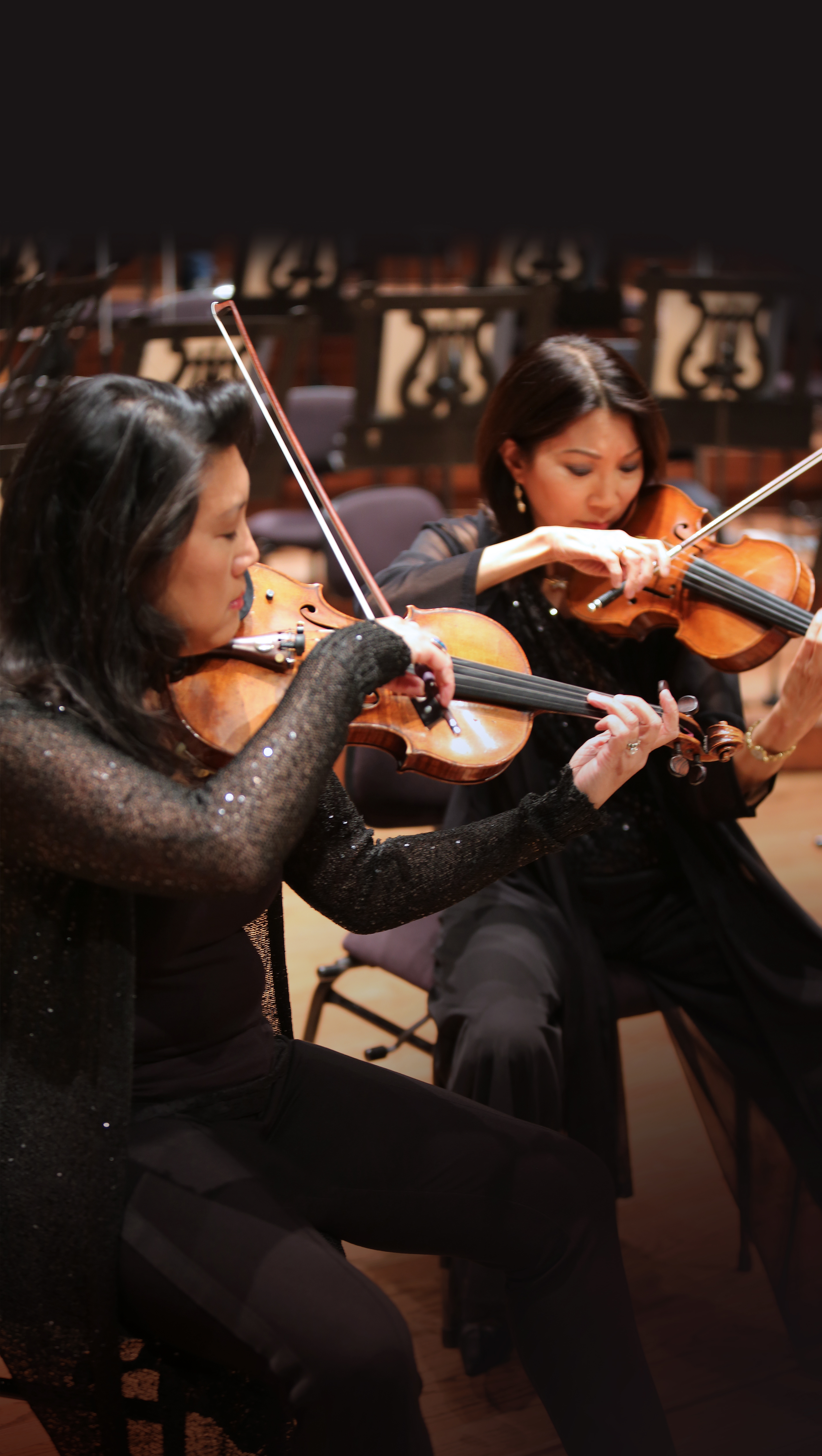 Kelly and Suzanne playing the violin.